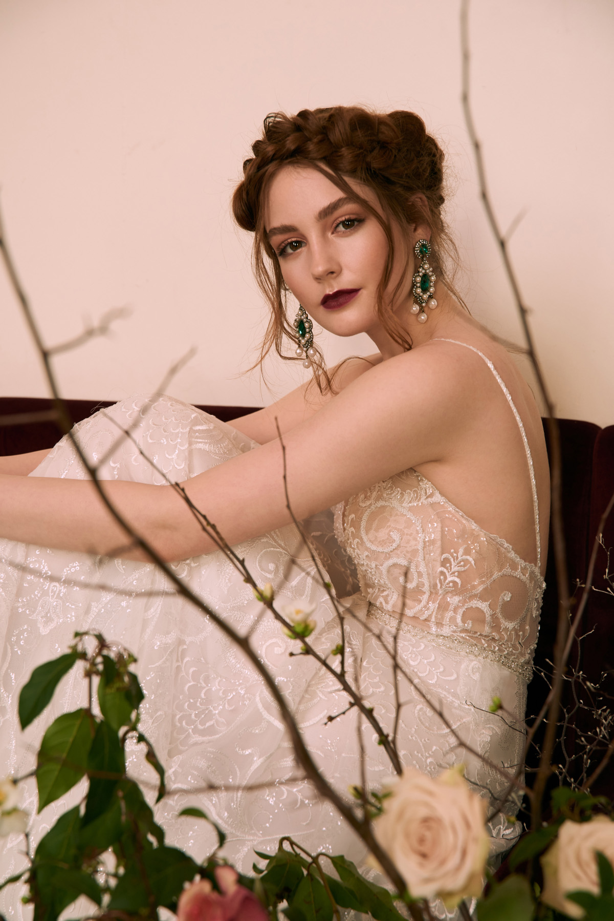 A girl sitting by wearing a beautiful wedding dress